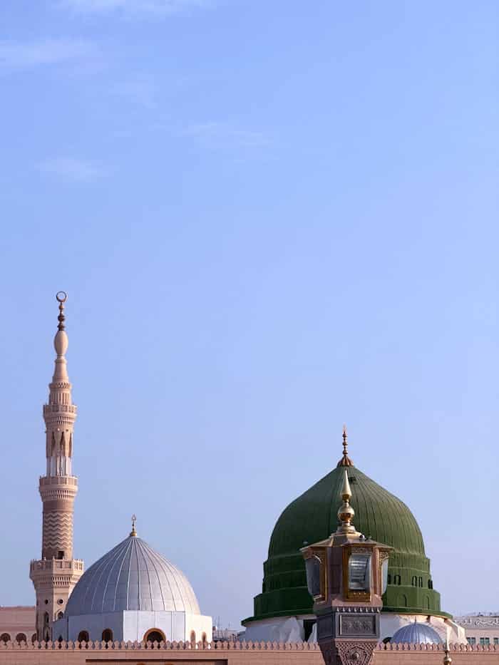 A serene photo showcasing the domes and minaret of Masjid An-Nabawi in Madinah, Saudi Arabia